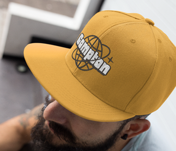 man wearing compton general business logo on yellow hat