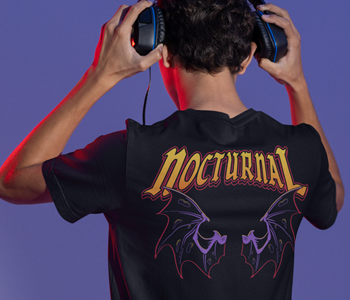 A man wearing a Halloween-themed t-shirt with headphones.